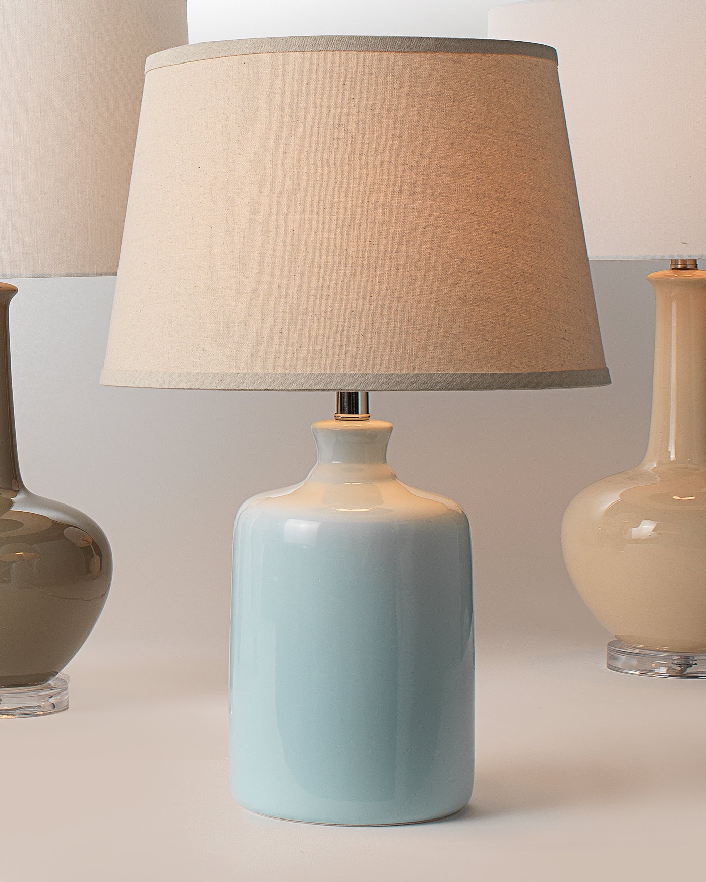 Milk Jug Table Lamp in Light Blue Glass With Cone Shade in Pebble Linen